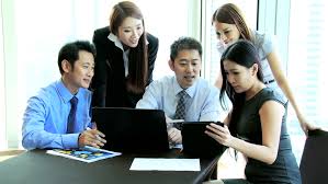 Business People looking at English Names On a computer